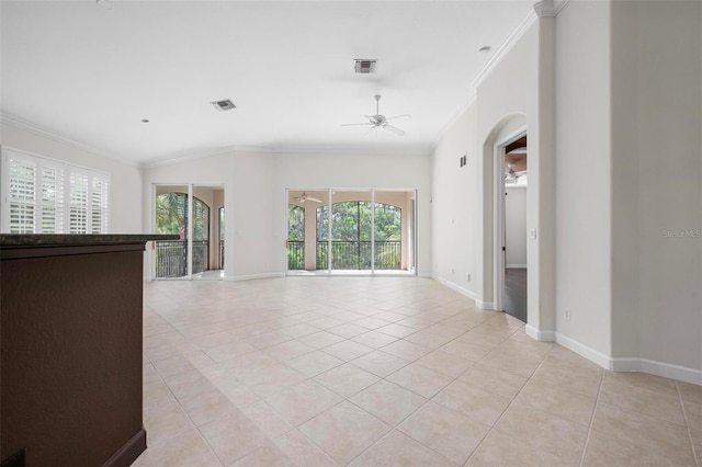 114 Bella Vista Ter Unit 6C, Nokomis, FL 34275 - unfurnished room featuring ceiling fan, ornamental molding, healthy amount of natural light, light tile patterned flooring, and arched walkways