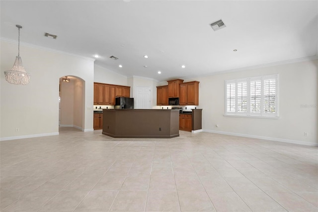 114 Bella Vista Ter Unit 6C, Nokomis, FL 34275 - kitchen with black appliances, open floor plan, ornamental molding, arched walkways, and dark countertops