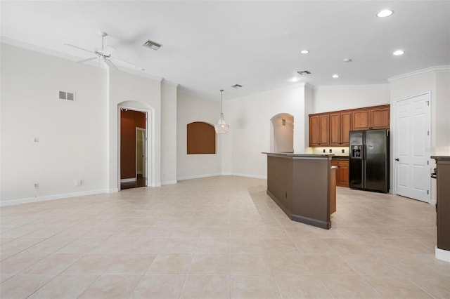 114 Bella Vista Ter Unit 6C, Nokomis, FL 34275 - kitchen featuring black refrigerator with ice dispenser, arched walkways, ornamental molding, recessed lighting, and open floor plan