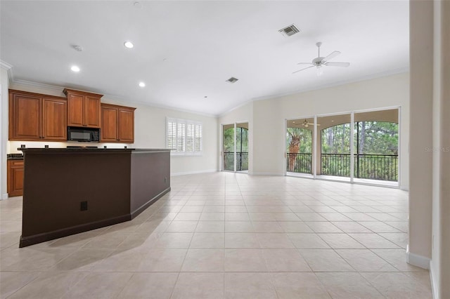 114 Bella Vista Ter Unit 6C, Nokomis, FL 34275 - kitchen featuring ornamental molding, open floor plan, dark countertops, ceiling fan, and brown cabinets