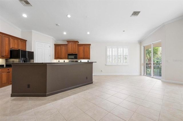 114 Bella Vista Ter Unit 6C, Nokomis, FL 34275 - kitchen with black appliances, dark countertops, ornamental molding, brown cabinets, and light tile patterned floors