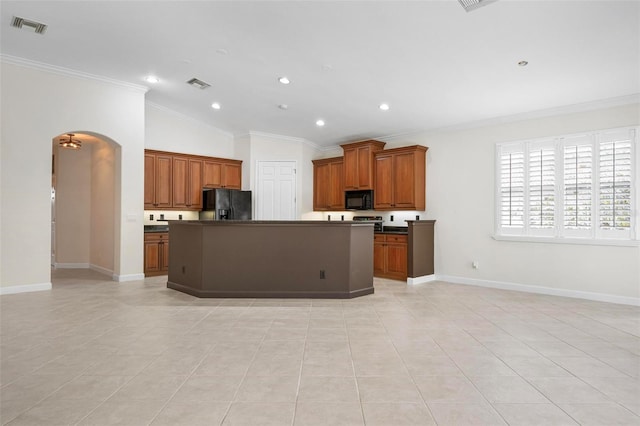 114 Bella Vista Ter Unit 6C, Nokomis, FL 34275 - kitchen featuring black appliances, dark countertops, arched walkways, crown molding, and brown cabinets