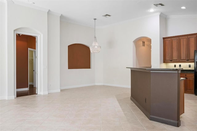 114 Bella Vista Ter Unit 6C, Nokomis, FL 34275 - kitchen with arched walkways, dark countertops, light tile patterned floors, crown molding, and pendant lighting