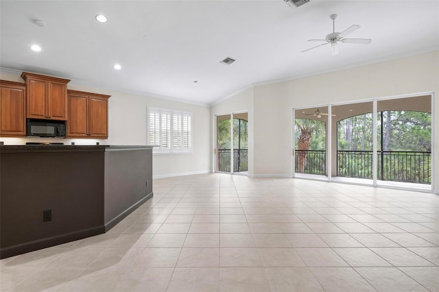 114 Bella Vista Ter Unit 6C, Nokomis, FL 34275 - kitchen featuring black microwave, ceiling fan, ornamental molding, dark countertops, and lofted ceiling