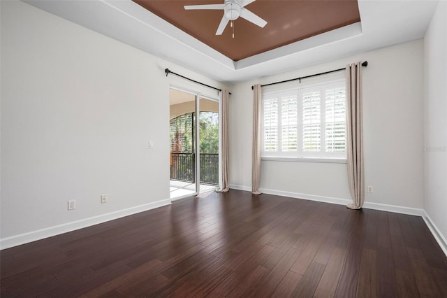 114 Bella Vista Ter Unit 6C, Nokomis, FL 34275 - spare room with a raised ceiling, a ceiling fan, and dark wood-style flooring