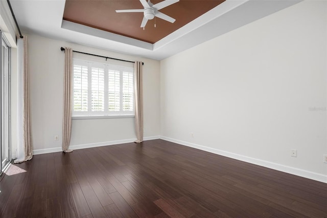 114 Bella Vista Ter Unit 6C, Nokomis, FL 34275 - spare room with a raised ceiling, a ceiling fan, and dark wood-style flooring