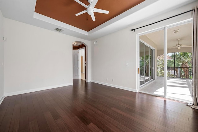 114 Bella Vista Ter Unit 6C, Nokomis, FL 34275 - spare room with a ceiling fan, a raised ceiling, arched walkways, and wood finished floors