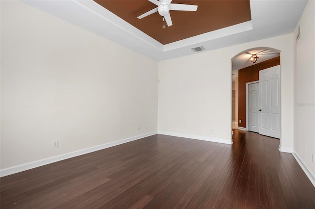 114 Bella Vista Ter Unit 6C, Nokomis, FL 34275 - unfurnished room with a raised ceiling, arched walkways, ceiling fan, and dark wood finished floors