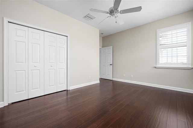 114 Bella Vista Ter Unit 6C, Nokomis, FL 34275 - unfurnished bedroom featuring dark wood-style floors, a closet, and a ceiling fan
