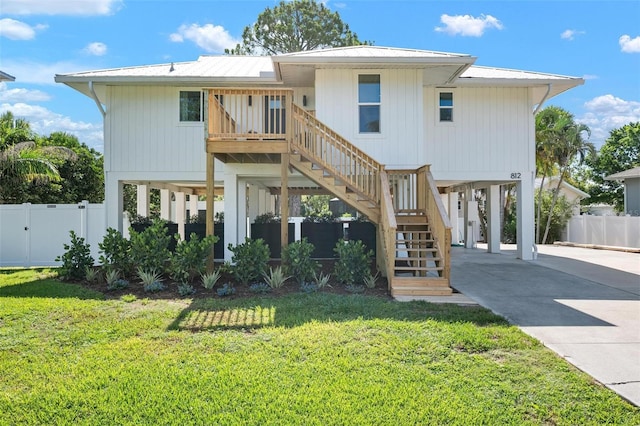 812 Garland Ave, Nokomis, FL 34275 - rear view of property featuring a carport, stairs, and concrete driveway