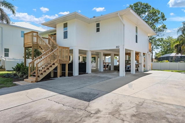 812 Garland Ave, Nokomis, FL 34275 - rear view of house with a carport, stairs, and driveway