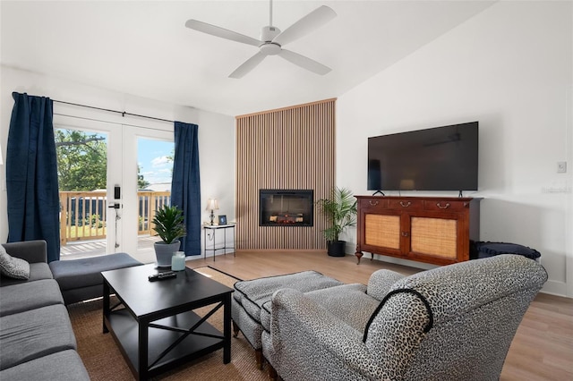 812 Garland Ave, Nokomis, FL 34275 - living area featuring wood finished floors, a ceiling fan, lofted ceiling, a glass covered fireplace, and french doors