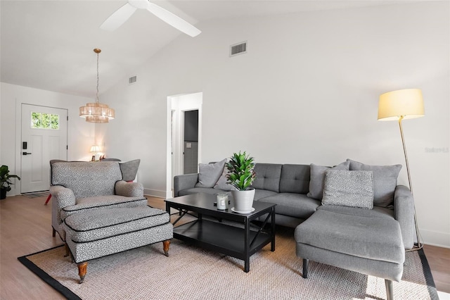 812 Garland Ave, Nokomis, FL 34275 - living room with light wood finished floors, beam ceiling, high vaulted ceiling, ceiling fan, and a chandelier