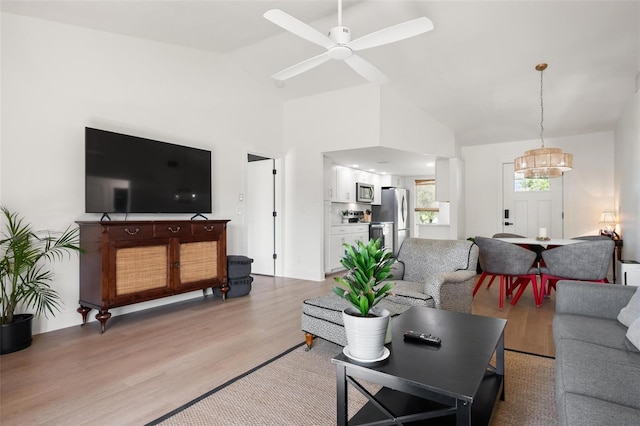 812 Garland Ave, Nokomis, FL 34275 - living area with a chandelier, high vaulted ceiling, light wood-style flooring, and ceiling fan