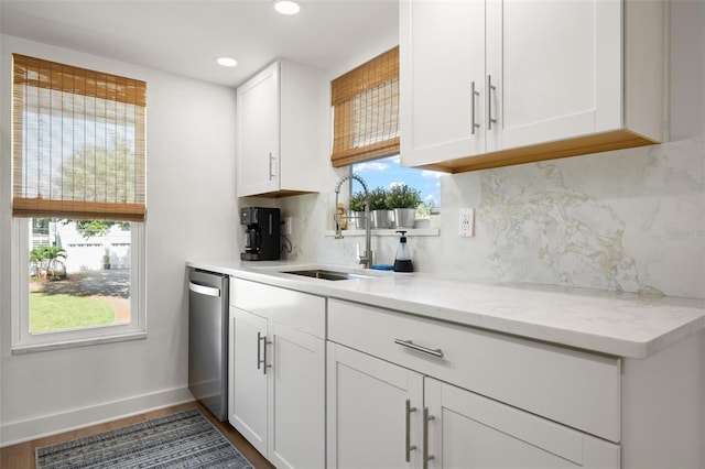 812 Garland Ave, Nokomis, FL 34275 - kitchen featuring stainless steel dishwasher, white cabinets, decorative backsplash, recessed lighting, and light stone countertops