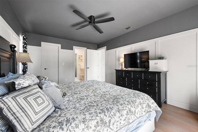 812 Garland Ave, Nokomis, FL 34275 - bedroom with light wood finished floors, ensuite bathroom, and ceiling fan