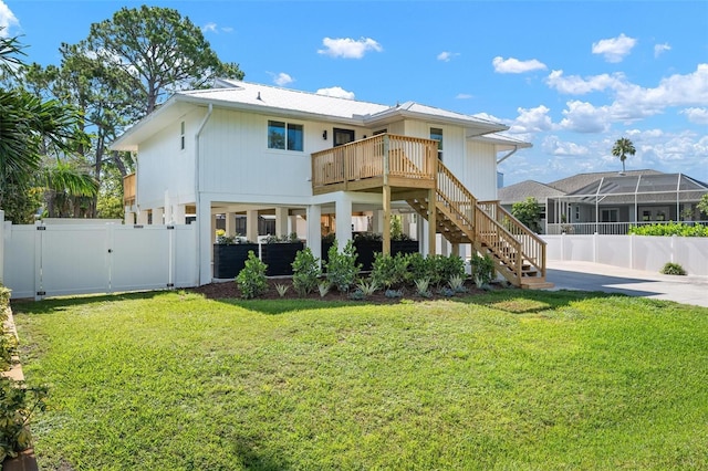 812 Garland Ave, Nokomis, FL 34275 - back of property featuring a fenced backyard, a gate, stairs, and a wooden deck