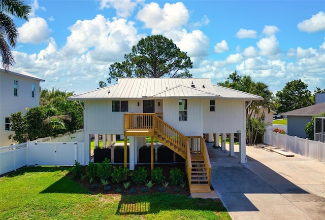 812 Garland Ave, Nokomis, FL 34275 - back of property with a gate, concrete driveway, a carport, stairs, and a metal roof