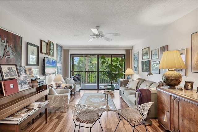 1088 Bird Bay Way Unit 307, Venice, FL 34285 - living area featuring wood finished floors, a textured ceiling, and ceiling fan