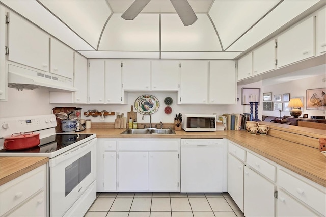 1088 Bird Bay Way Unit 307, Venice, FL 34285 - kitchen featuring white appliances, under cabinet range hood, light tile patterned floors, and light countertops