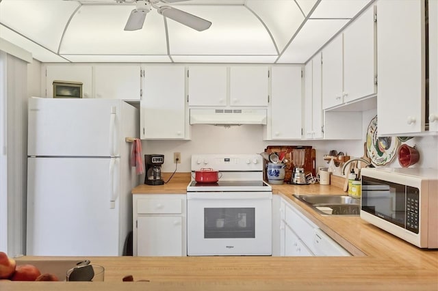 1088 Bird Bay Way Unit 307, Venice, FL 34285 - kitchen with white appliances, under cabinet range hood, light countertops, and white cabinets