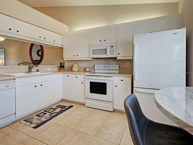903 Addington Ct Unit 203, Venice, FL 34293 - kitchen with white appliances, light countertops, light tile patterned flooring, and white cabinetry