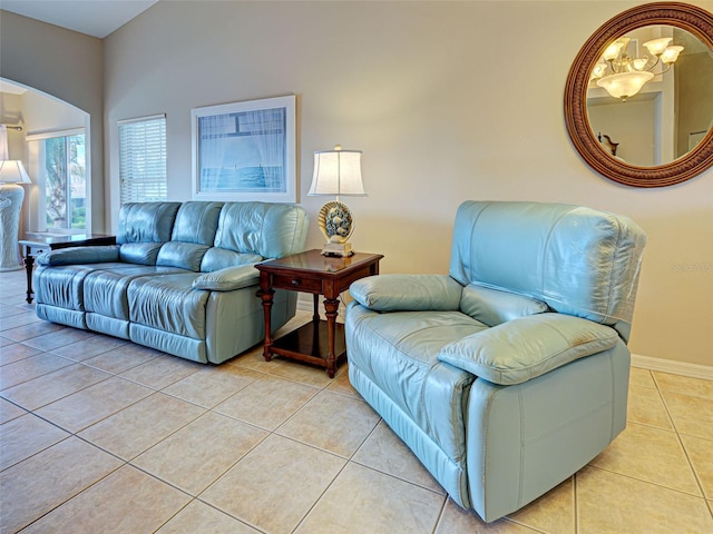 903 Addington Ct Unit 203, Venice, FL 34293 - living area with light tile patterned floors, arched walkways, and a chandelier