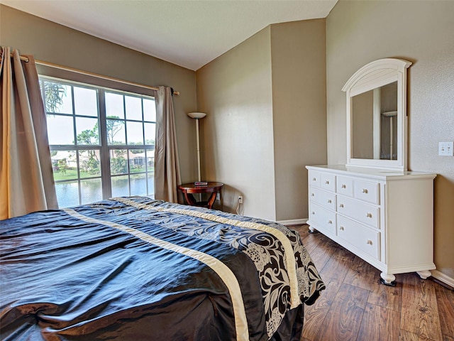 903 Addington Ct Unit 203, Venice, FL 34293 - bedroom with dark wood finished floors and a water view