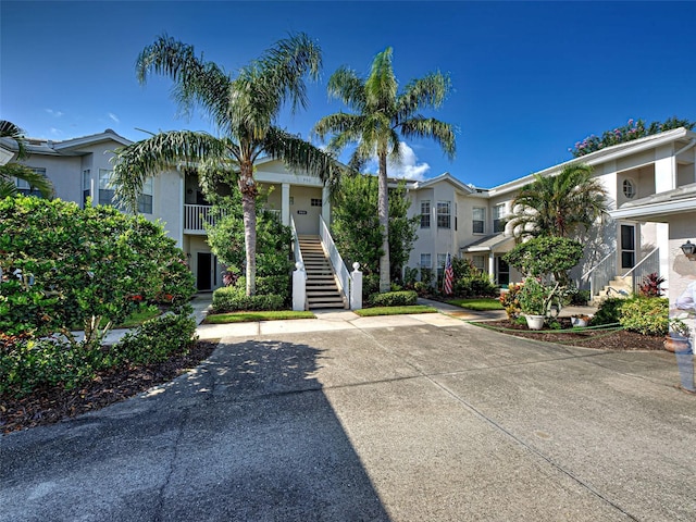 903 Addington Ct Unit 203, Venice, FL 34293 - view of front facade featuring stairs and stucco siding