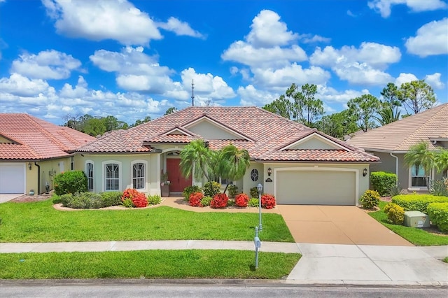 2471 Silver Palm Rd, North Port, FL 34288 - mediterranean / spanish-style house with an attached garage, driveway, a tile roof, stucco siding, and a front yard