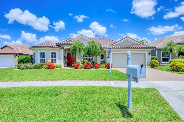 2471 Silver Palm Rd, North Port, FL 34288 - mediterranean / spanish house featuring an attached garage, stucco siding, concrete driveway, and a front lawn