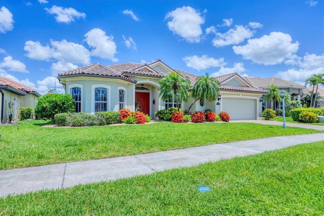 2471 Silver Palm Rd, North Port, FL 34288 - mediterranean / spanish-style home with a garage, a front yard, stucco siding, and a tiled roof
