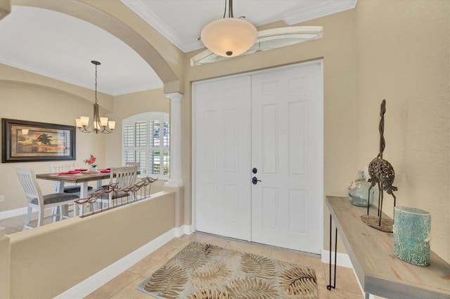 2471 Silver Palm Rd, North Port, FL 34288 - foyer entrance with arched walkways, crown molding, a chandelier, ornate columns, and light tile patterned flooring