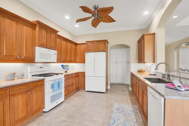 2471 Silver Palm Rd, North Port, FL 34288 - kitchen with white appliances, arched walkways, a ceiling fan, light stone counters, and tasteful backsplash
