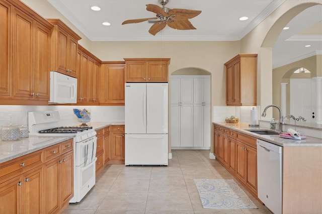 2471 Silver Palm Rd, North Port, FL 34288 - kitchen featuring white appliances, ceiling fan, arched walkways, crown molding, and decorative backsplash