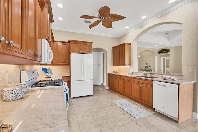 2471 Silver Palm Rd, North Port, FL 34288 - kitchen with white appliances, crown molding, light countertops, a ceiling fan, and tasteful backsplash