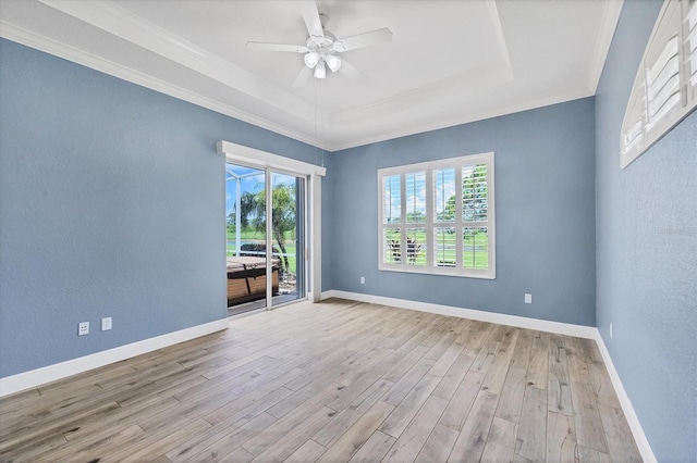 2471 Silver Palm Rd, North Port, FL 34288 - spare room featuring plenty of natural light, wood finished floors, ceiling fan, a raised ceiling, and crown molding