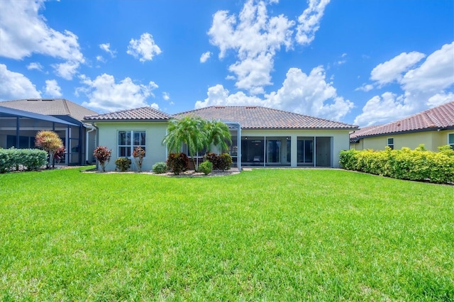 2471 Silver Palm Rd, North Port, FL 34288 - back of property featuring a tiled roof, a lawn, and stucco siding