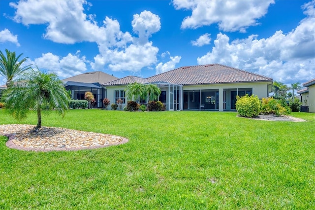 2471 Silver Palm Rd, North Port, FL 34288 - rear view of property with a yard, a tiled roof, and stucco siding