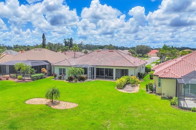 2471 Silver Palm Rd, North Port, FL 34288 - rear view of house featuring a tiled roof, a lawn, and a lanai