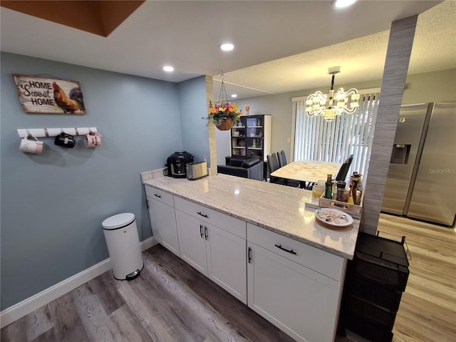 4022 Beaver Ln Unit 1000G, Port Charlotte, FL 33952 - kitchen with stainless steel fridge, a chandelier, light wood-type flooring, white cabinetry, and recessed lighting