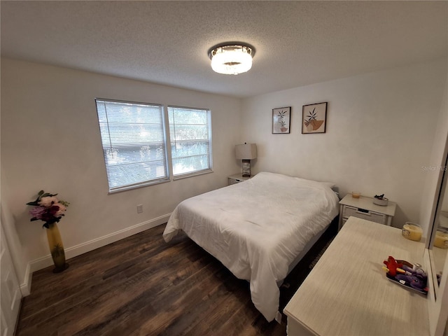4022 Beaver Ln Unit 1000G, Port Charlotte, FL 33952 - bedroom with dark wood-style flooring and a textured ceiling