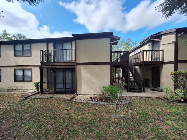 4022 Beaver Ln Unit 1000G, Port Charlotte, FL 33952 - rear view of property with stairs, stucco siding, and a wooden deck