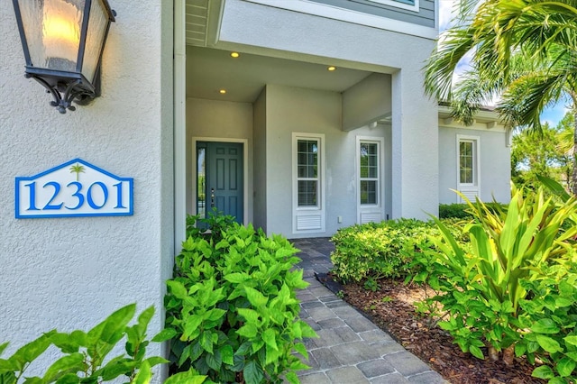 12301 Auburndale Ct, Venice, FL 34293 - view of exterior entry featuring stucco siding