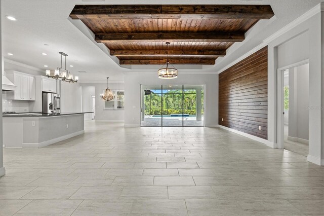 12301 Auburndale Ct, Venice, FL 34293 - unfurnished living room with a chandelier, a wood ceiling with exposed beams, wooden walls, and recessed lighting