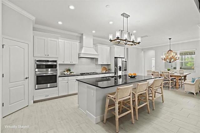 12301 Auburndale Ct, Venice, FL 34293 - kitchen featuring premium range hood, a chandelier, stainless steel appliances, dark countertops, and backsplash