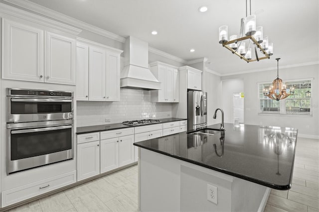 12301 Auburndale Ct, Venice, FL 34293 - kitchen featuring a chandelier, stainless steel appliances, custom range hood, decorative backsplash, and an island with sink