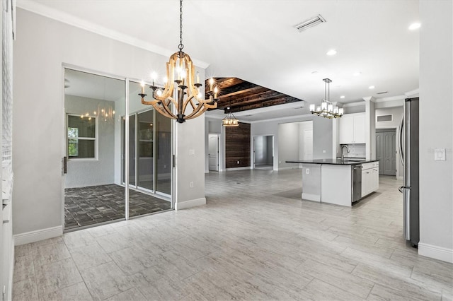 12301 Auburndale Ct, Venice, FL 34293 - kitchen featuring a chandelier, open floor plan, dark countertops, appliances with stainless steel finishes, and white cabinets