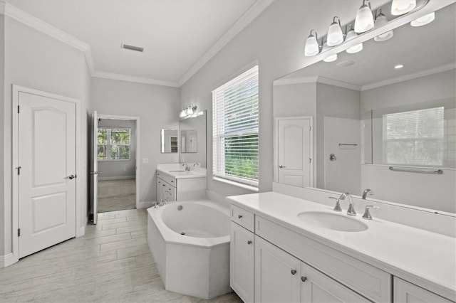 12301 Auburndale Ct, Venice, FL 34293 - bathroom featuring two vanities, a bath, ornamental molding, and wood finished floors