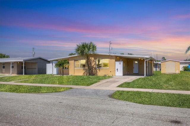 210 Duxbury Ave, Port Charlotte, FL 33952 - single story home with driveway, a carport, stucco siding, a storage shed, and a yard